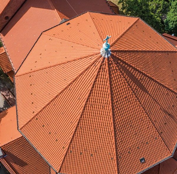 Historyczny zamek z wieżami i dachem z dachówki Creaton Melodie, widok panoramiczny z lotu ptaka