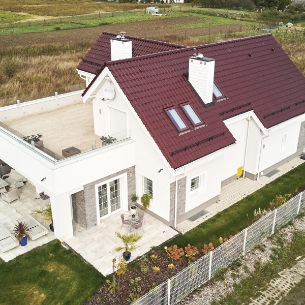 Dwuspadowy dach z dachówki Creaton Sinfonie w kolorze czerwieni winnej – ujęcie dronem