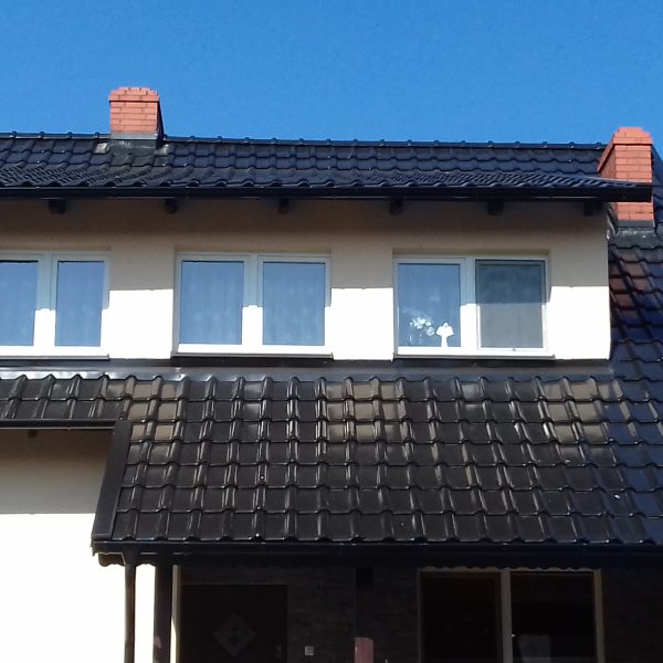 Pokrycie dachowe z dachówki Röben Piemont w połączeniu czerni i brązu.